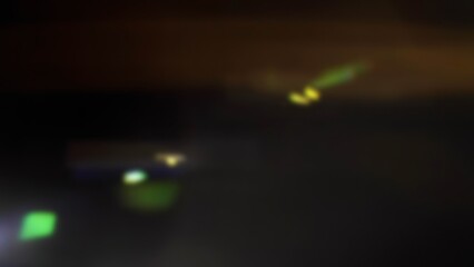 Cinematic anamorphic lens flares with vivid light streaks and reflections against a black background, creating a dynamic and glowing optical effect.