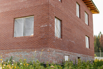 Unfinished two-storey brick house. High foundation