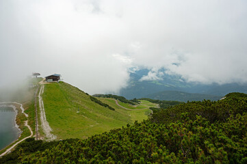 Obraz premium panorama on top of the Steinplatte mountain near Waidring in Tyrol in Austria with foggy clouds over a lake