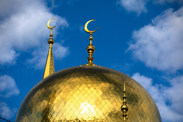 There is a beautiful golden dome featuring a crescent moon atop it © Victor Kaprov