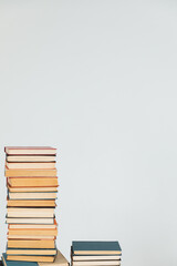 Stacks of old educational books against the wall in the library as a background