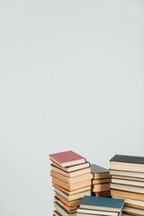 Stacks of old educational books against the wall in the library as a background