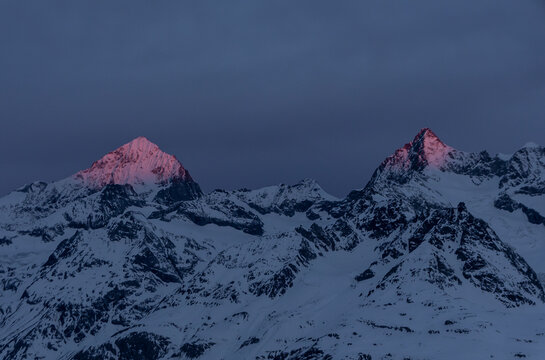 Snow-covered mountain peaks at twilight