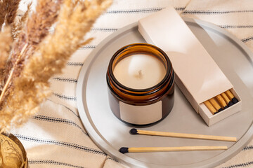 Cozy home decor scene with scented candle and matches