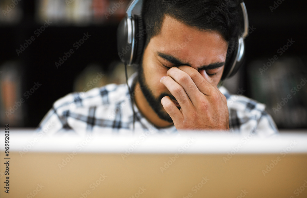 Aufkleber man, university student and eye strain on computer with headphones in library for internet, online e