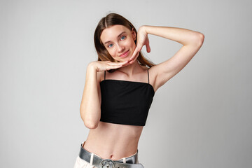 Fototapeta premium Smiling Young Woman Against White Background in Studio