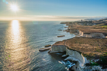 Beautiful sunset landscape along Highway 1 in California. Pacific Ocean coastline along the bay, aerial view. Travel and vacation concept.