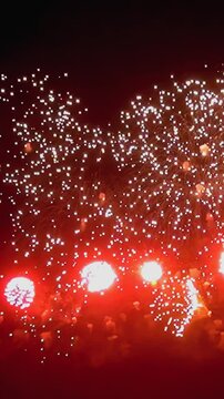 Experience the dazzling display of vibrant colors as fireworks burst in slow motion, creating a mesmerizing dance of light and energy against the dark canvas of the night.