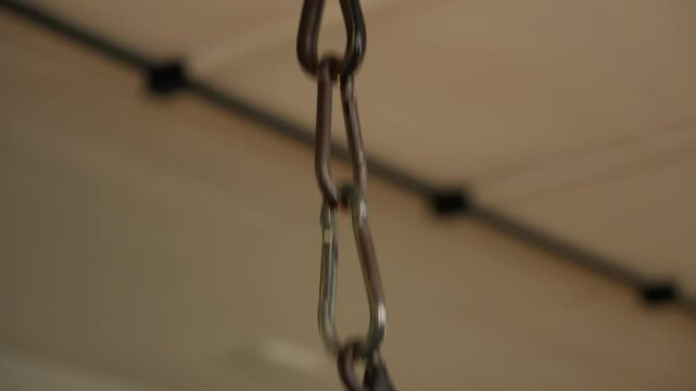 Close-Up of Hands Gripping Gym Equipment for Strength Training. Focused shot of hands holding gym equipment, perfect for workout and strength training-related videos.