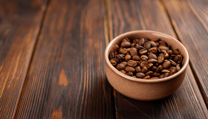 Fototapeta premium Roasted coffee beans in ceramic bowl on dark wooden table. Tasty and aromatic beverage.