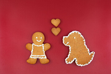 Smiling gingerbread woman, dog and hearts, copy space