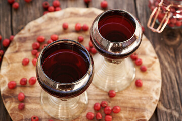 Medicinal wine with hawthorn berries in two glass cups