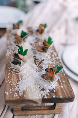 Gourmet Appetizers on Rustic Wooden Board