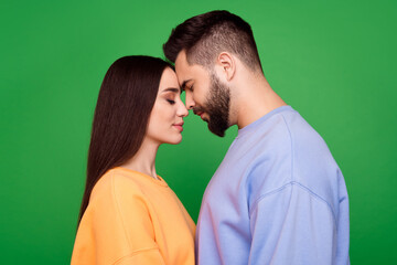 Photo of enamored enchanted couple wear stylish clothes isolated on green color background