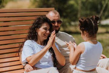 happy family is relaxing in the city park