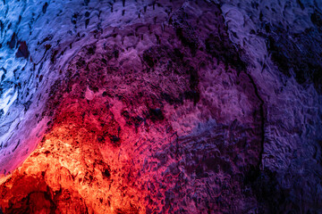 Abstract cave texture with vivid color gradients, inside a volcanic tube