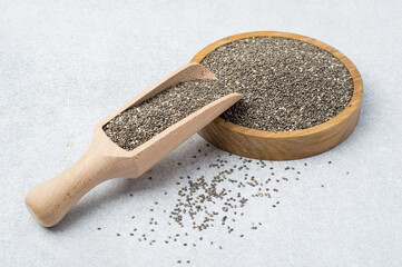 Chia seeds in a wooden bowl on a light background. Superfood, Horizontal.