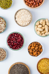 Variety of grains, nuts, seeds, legumes in bowls on a light background. Healthy foods. Healthy lifestyle, Vegetarianism. .