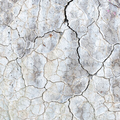 abstract line pattern on white painted part of conrete with cracks
