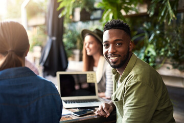 Happy, meeting and portrait of black man in cafe with team for international client project. Industry, creative and public relations director in business discussion with stakeholders at coffee shop.