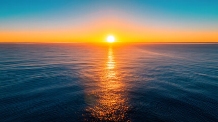 Obraz premium A stunning ocean view from a high balcony with the sun rising over the horizon and casting a golden glow on the water.