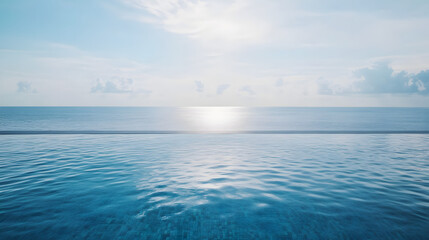 Fototapeta premium A stunning ocean view from a luxury infinity pool with the water blending seamlessly into the horizon.