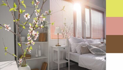 Vase with blooming branches in interior of light bedroom. Different color patterns