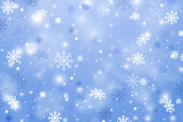 Chaotic winter sky with falling snowflakes on a blue background. Scattered snowflakes, winter landscape