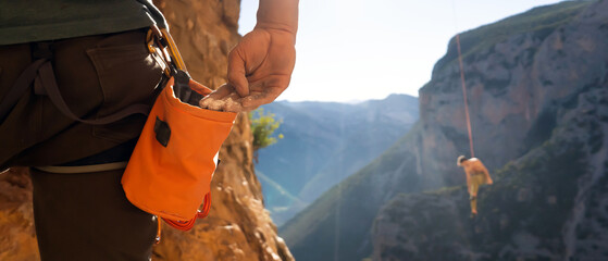 Man is climbing with magnesium powder.