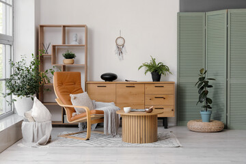 Interior of living room with armchair, glucophone and Tibetan singing bowl