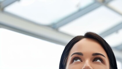 A woman CEO boss, looking up at a glass ceiling in a business office building. Female determination in the workplace.