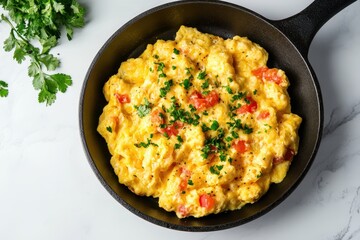 Mexican recipes Scrambled Eggs served in skillet on marble table with copy space