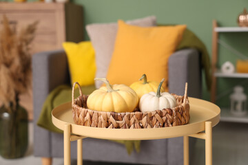 Coffee table with pumpkins in living room. Closeup