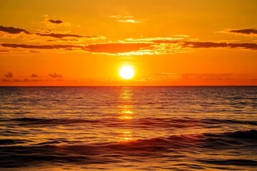 Fototapeta premium A captivating golden sunset over a calm sea with orange hues reflecting off the water, delivering a serene and tranquil scene that highlights nature’s spectacular beauty.