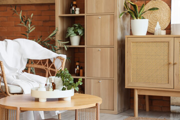 Coffee table, shelving unit and armchair in stylish bathroom