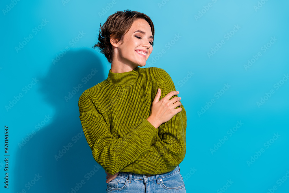 Wall mural photo of cheerful lovely girl wear trendy khaki warm clothes hug herself enjoy cozy time isolated on