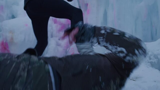 Man reaching for paintball gun but getting shot by woman - shaky cam