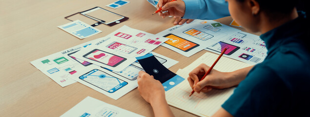 Panorama banner of startup company employee planning on user interface prototype for mobile application or website in office. UX UI designer brainstorm user friendly interface plan. Synergic