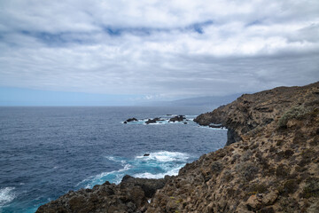 High rock cliffs on the coastline above the sea. Concept: Nature, sea, marine, maritime.