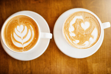 Heart, coffee cups in restaurant or cafe for customer service, order or design by barista. Background, hot beverage and small business with creativity in bistro or hospitality industry for latte art