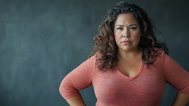 Serious overweight hispanic woman with her hands on the hips looking determined while making eye contact : Generative AI