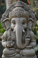 Close up of a grey stone Ganesha statue with intricate details
