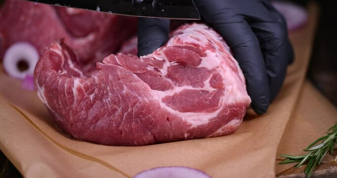 a sliced piece of pork meat from the neck, soft pork meat on a cutting board
