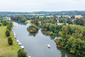 Aerial view of a river with boats on the side of the river