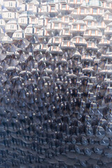 Fototapeta premium Kaleidoscopic reflection of city buildings and passersby