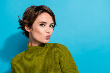 Photo of adorable gorgeous girl wear stylish green clothes send kiss empty space isolated on cyan color background