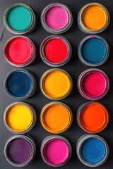 An Abstract Top-Down Shot Of Various Open Paint Cans, Each Filled With A Different Vivid Color