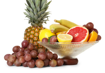 Glass vase with different fresh fruits isolated on white