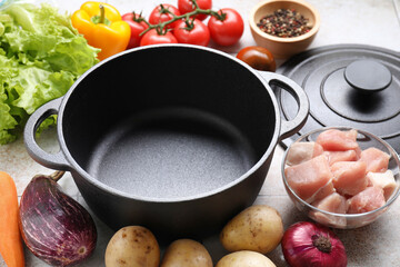 Uncooked ingredients for stew on tiled table, closeup