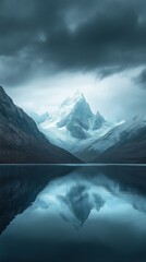 Fototapeta premium Snow-capped mountain reflected in calm lake under dramatic sky